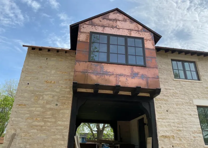 Copper metal panel facade on a stone building for Metal Roof Coating in Eudora