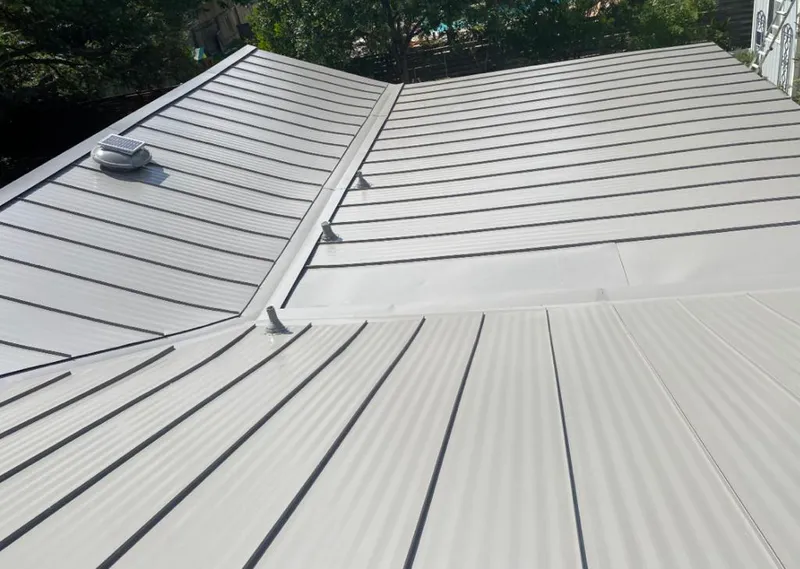 Solar attic fan installed on a metal roof for Roof Ventilation in Eudora